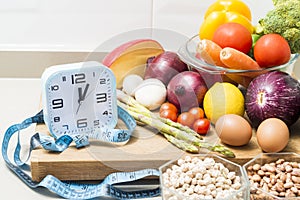 Still life with a clock, a tape measure and healthy food