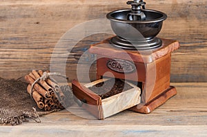 still life with coffee beans and old coffee mill on wooden table
