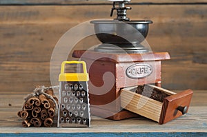 still life with coffee beans and old coffee mill on wooden table