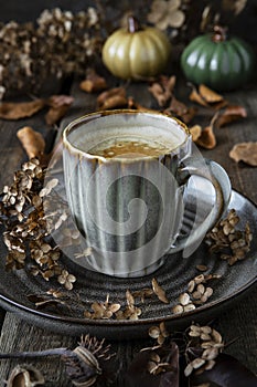Still life with coffee cup on wooden background