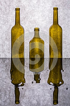 Still life with colored bottles on a reflective surface