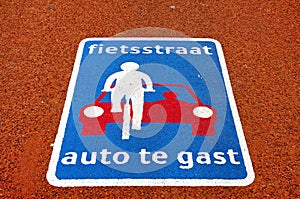 Still life of colorful road sign on red asphalt