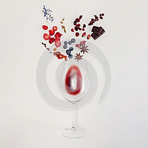 Still life composition with wine glass and flavors of red wine.