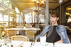 Still life concept. Beautiful young girl relaxing in a cafe