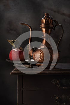 Still life with a copper jug for wine photo