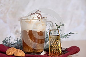 Still life with a cup of coffee latte, cookies and cade branch in Christmas mood