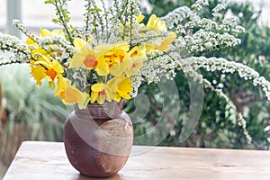 Still life with daffodil flowers in vase on table