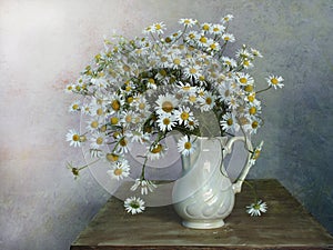 Still life with daisies on a multicolored background.