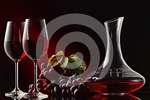 Still life with a decanter of red wine, glasses and grapes