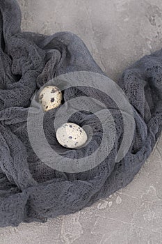 Still life of decorated quail eggs on a textured background. Rustic. Easter celebration concept