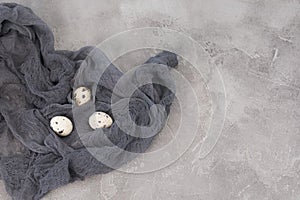 Still life of decorated quail eggs on a textured background. Rustic. Easter celebration concept