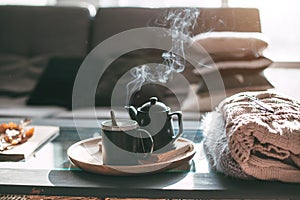 Tea with steam in room in morning sunlight