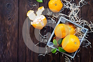 Still life, diet and nutrition concept. Fresh and juicy oranges and tangerines on a wooden table.