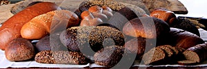 Still life with different types of bread: black, rye, white bread, bread with seeds. bread and wheat ears.