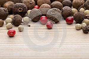 Still life with dried pepper multicolored peas, on a light wooden background.