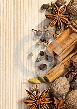 Still life with dried spices on a light wooden background.