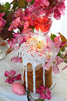 Still life with Easter cakes, painted eggs, wine and flowers of paradise apple