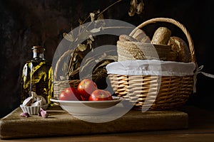 Still life with extra virgin olive oil, tomatoes, garlic and bread