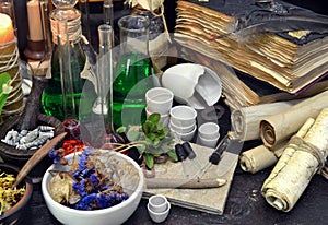 Still life with flasks, magic components, scrolls and books