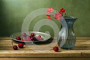 Still life with flowers and cherries photo