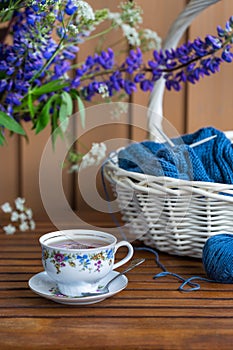 Still life with flowers, knitting in the basket