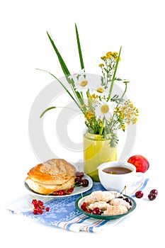 Still life with flowers and red currant bun photo