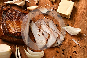 Still life of food in a rural style on a dark wood background, sliced lard and garlic, cheese and onion, concept of fresh