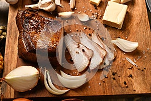 Still life of food in a rural style on a dark wood background, sliced lard and garlic, cheese and onion, concept of fresh