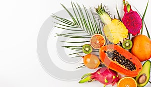 Still life with fresh assorted exotic fruits on a palm leaf