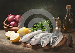 Still life with fresh fish and ingredients for cooking