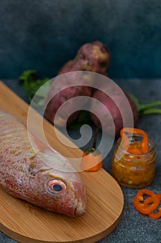 Still life with fresh fish and ingredients for cooking photo