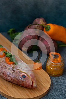 Still life with fresh fish and ingredients for cooking photo