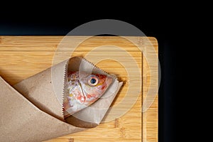 Still life with fresh fish and ingredients for cooking photo