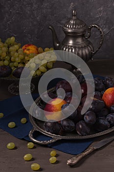 Still life with fresh fruit and antique dishes