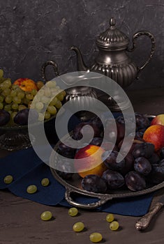Still life with fresh fruit and antique dishes