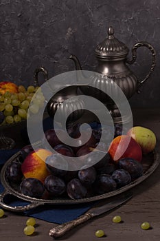Still life with fresh fruit and antique dishes