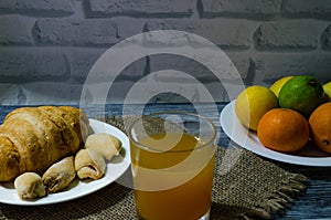 Still life with fresh fruits and glass of juice on the wooden background