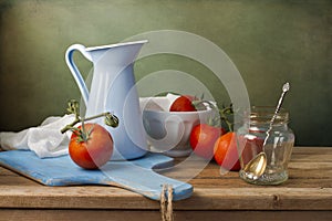 Still life with fresh tomatoes and tableware