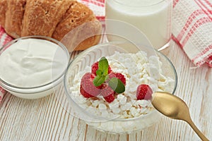 Still life with fresh village cottage cheese  with strawberries, sour cream, yogurt and  croissant. Healthy food. Dairy producst