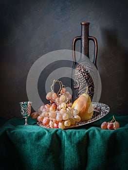 Still life with fruit, wine and drapery