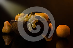 Still-life with fruit in a wooden dish