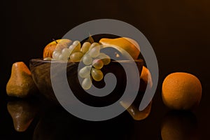 Still-life with fruit in a wooden dish