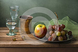 Still life with fruits and glasses of water