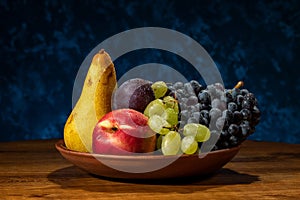 Still life with fruits. Grapes, nectarines, pears and plums.