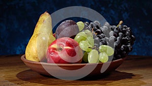 Still life with fruits. Grapes, nectarines, pears and plums.