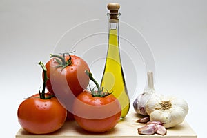 Still life with garlic, oil and tomatoes