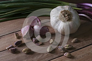 Still life garlic, pistachio and leek photo