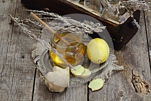 Still life with ginger,lemon,honey and herbs de Provence