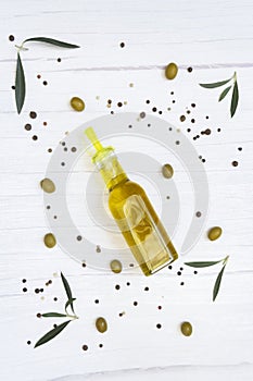 Still life with a glass container filled with virgin olive oil along