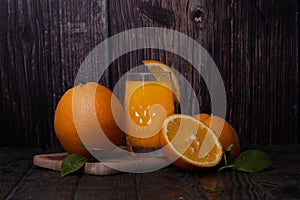 Still life of a glass of fresh orange juice on a vintage wooden table with copy space background